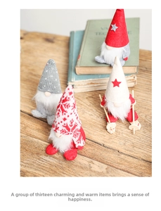 Close-up of four handmade Christmas gnomes on a wooden table with festive Nordic props