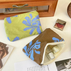 Detail of floral canvas pouches showing storage capacity for cosmetics and small items