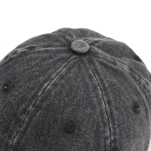 Detailed macro view of the washed denim baseball cap crown with stitched eyelets