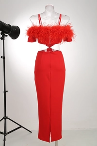 Detail of red off-shoulder evening dress featuring feather trim and waist cut-outs