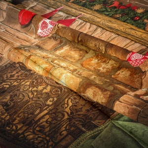 Close-up of bohemian Christmas tree tapestry with stone wall texture and festive wreath