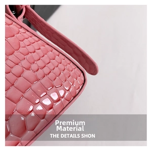 Macro shot of pink crocodile embossed patent leather material with high gloss finish