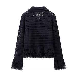 Detail of navy knit top featuring openwork mesh texture and long tassel trim at the hem