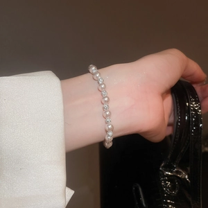 Close-up of elegant white pearl and rhinestone beaded bracelet on model wrist