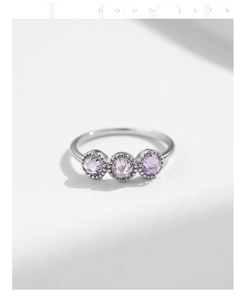 Detail of S925 sterling silver ring with three purple zircon stones and beaded edges