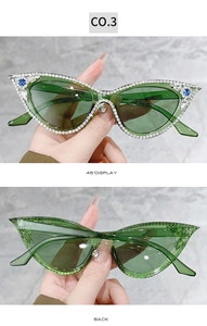 Detail of green cat-eye sunglasses with hand-set sparkling crystals on frame edges