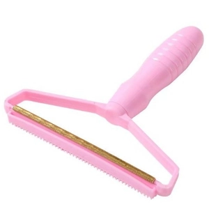 Pink manual lint remover for sweaters and coats with copper head for fabric hair removal