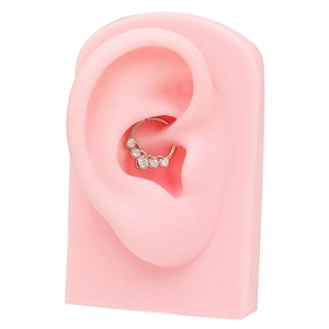 Silver-toned earring hoop featuring clear crystals on a pink ear model showcase