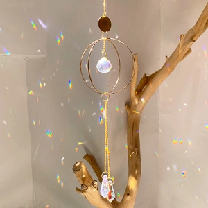Detail of hanging suncatcher crystal prisms reflecting colorful rainbow spots on wall
