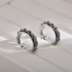 Polished stainless steel hoop earrings with unique braided texture in silver finish