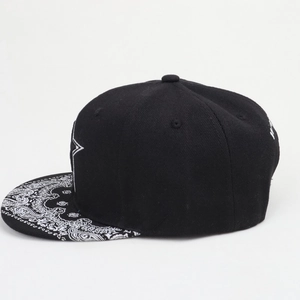 Detail of black snapback hat with paisley print brim and white embroidery details