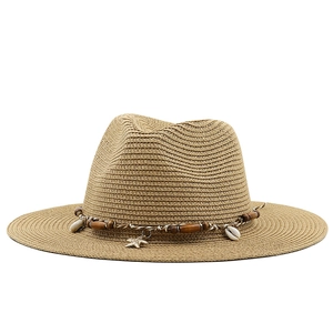 Women's straw Panama sun hat with boho shell and wood bead trim on white background