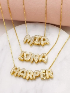 Detailed view of three gold name necklaces with MIA LUNA HARPER diamond pendants