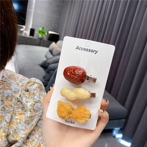 Detailed view of creative resin hair clips shaped like red dates, peanuts, and fried chicken