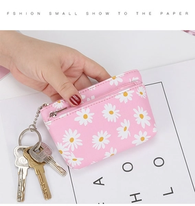 Pink daisy print mini pouch showing pebble faux leather texture and a zipper closure
