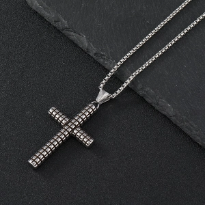 Polished silver stainless steel cross pendant with checkered texture on a box chain