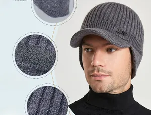 Detail of grey winter knit visor hat with warm ear flaps and JEANS metal logo