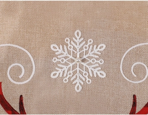 Detail of snowflake embroidery and faux pearl on linen Christmas tree skirt