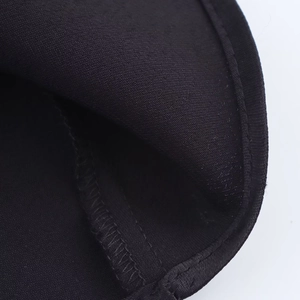 Close-up of black satin dress showing high-density knit texture and precise stitching detail