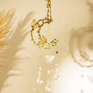 Close-up of crescent moon crystal wind chime with butterflies, shells and rainbow light