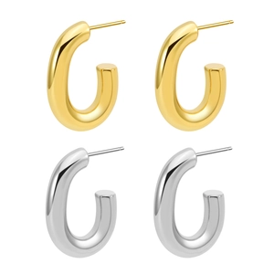 Close-up of gold and silver U-shaped chunky hoop earrings with a polished mirror finish