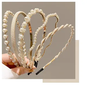 Close-up of white pearls and metal headbands with various elegant designs for girls