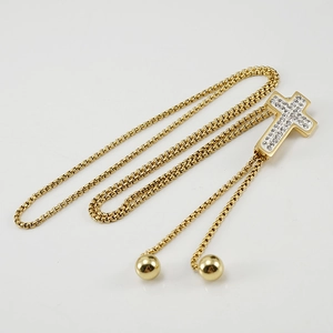 Detail of 18K gold-plated cross pendant necklace with sparkling zircon and box chain