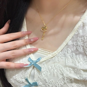 Elegant gold rocking horse necklace with sparkling cubic zirconia on a female wearer