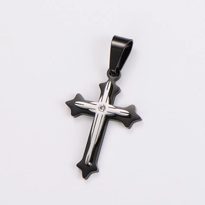 Close-up of a two-tone black and silver cross pendant with a center clear crystal stone