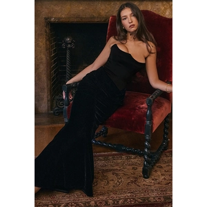 Luxurious velvet拼接 strapless black evening gown shown in an elegant interior setting