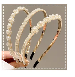 Detailed view of three pearl headbands with gold metal frames and non-slip design