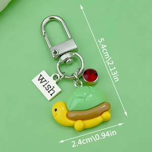 Cartoon turtle keychain pendant in green and yellow with wish tag and size 5.4cm x 2.4cm