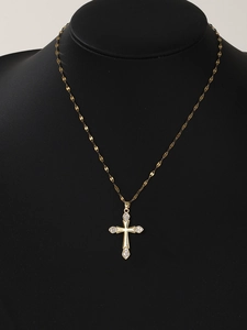 Close-up of golden cross necklace pendant with micro-inlaid zircon on a black bust