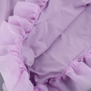 Macro shot of purple chiffon fabric with ruffle layers and detailed stitching textures