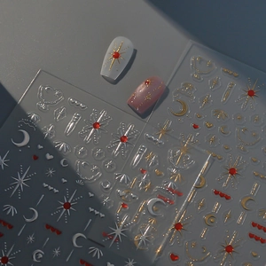 Macro detail of matte nail stickers featuring gold star and moon celestial patterns