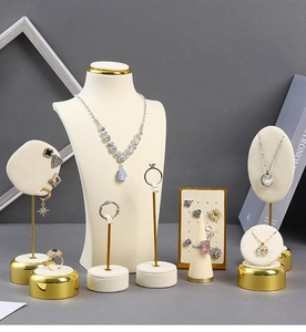 Detail view of premium cream velvet jewelry display set with gold metal bases