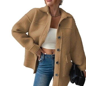 Close-up of khaki sherpa jacket showing plush texture and black buttons detail