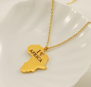 Detailed shot of golden Africa map pendant with I Love Africa engraving on shell plate