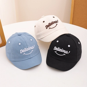 Detailed embroidery of Delicious lettering and smiley face on kids cotton baseball caps