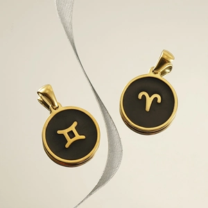 18K gold plated constellation necklaces with Gemini and Aries charms on a black base