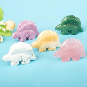 Detailed close-up of colorful crystal stegosaurus figurines in assorted polished gemstones