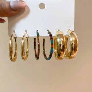 Close-up of assorted gold and tortoiseshell hoop earrings on a display card
