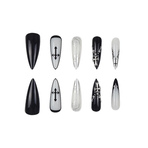 Gothic long stiletto press-on nails with black and white cross designs and rhinestones