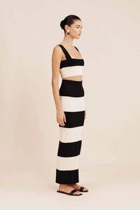 Detail of black and white striped knit set featuring a slim-fit crop top and long skirt
