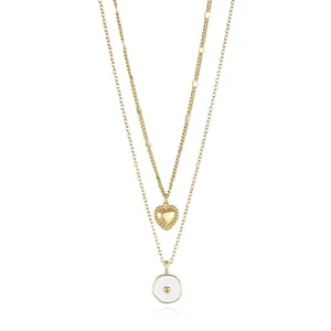 Detailed view of layered 18K gold plated double heart and enamel round pendant necklace