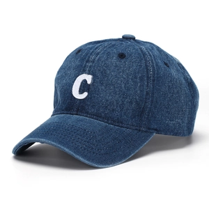 Detail view of navy denim baseball cap featuring white embroidered C letter on front