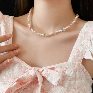 Minimalist pearl necklace with colorful crushed stones on a model neck
