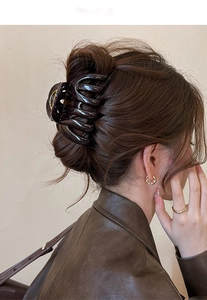 Brown tortoise shell acrylic shark hair claw clip worn in hair by a model