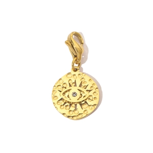Detailed view of golden evil eye pendant with lobster clasp and hammered texture finish