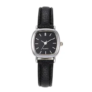 Detail of square silver quartz watch with black leather strap and minimalist dial